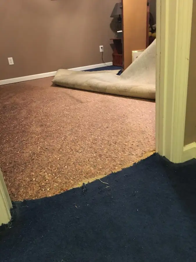 Carpet pad removal revealing water damage during Drying & Dehumidification in Waupaca
